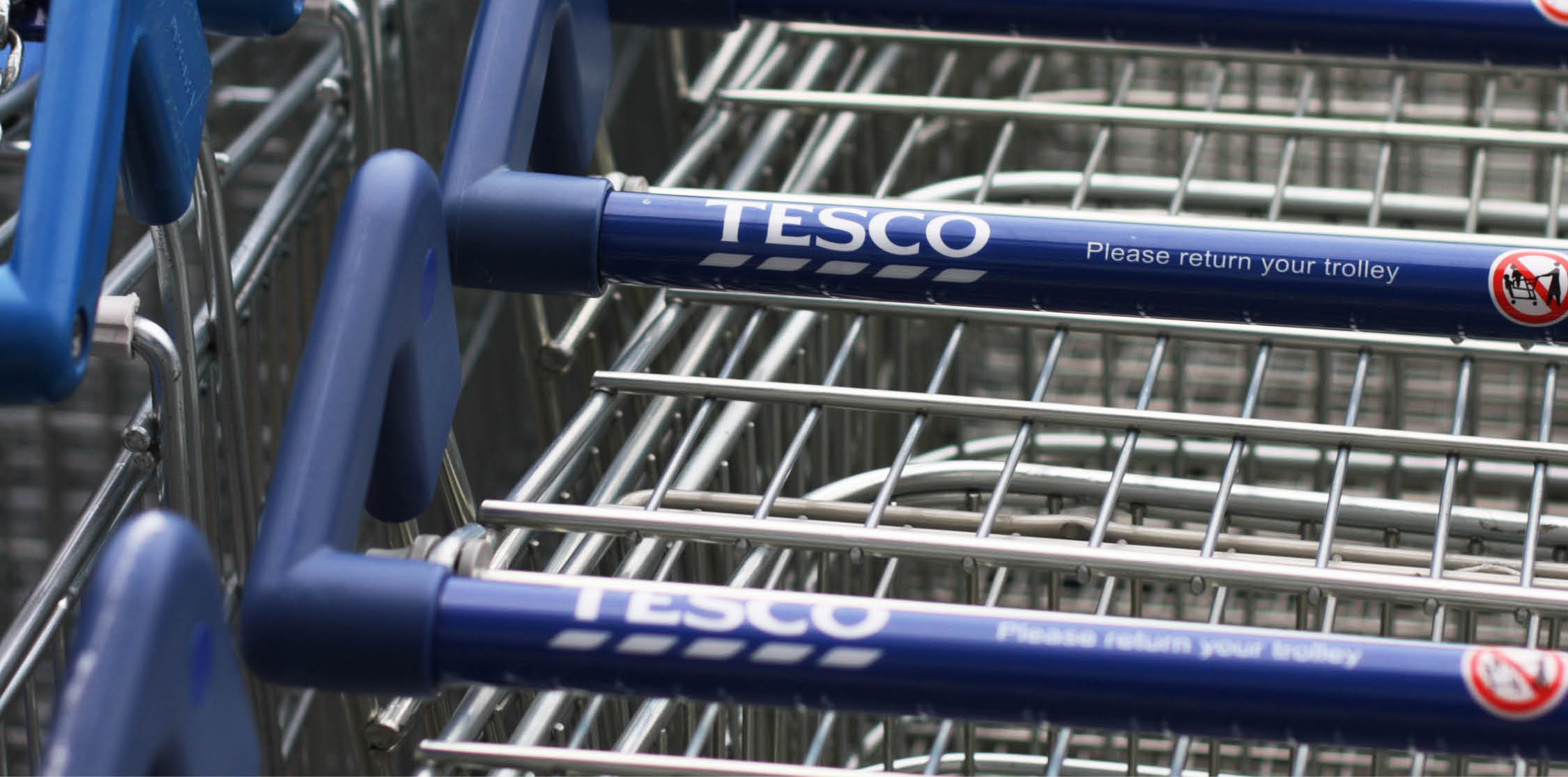 Bracknell, United Kingdom - January 17, 2012: Close up of shopping carts outside a Tesco supermarket. Tesco plc is a global grocery and general merchandise retailer headquartered in Cheshunt, United Kingdom.