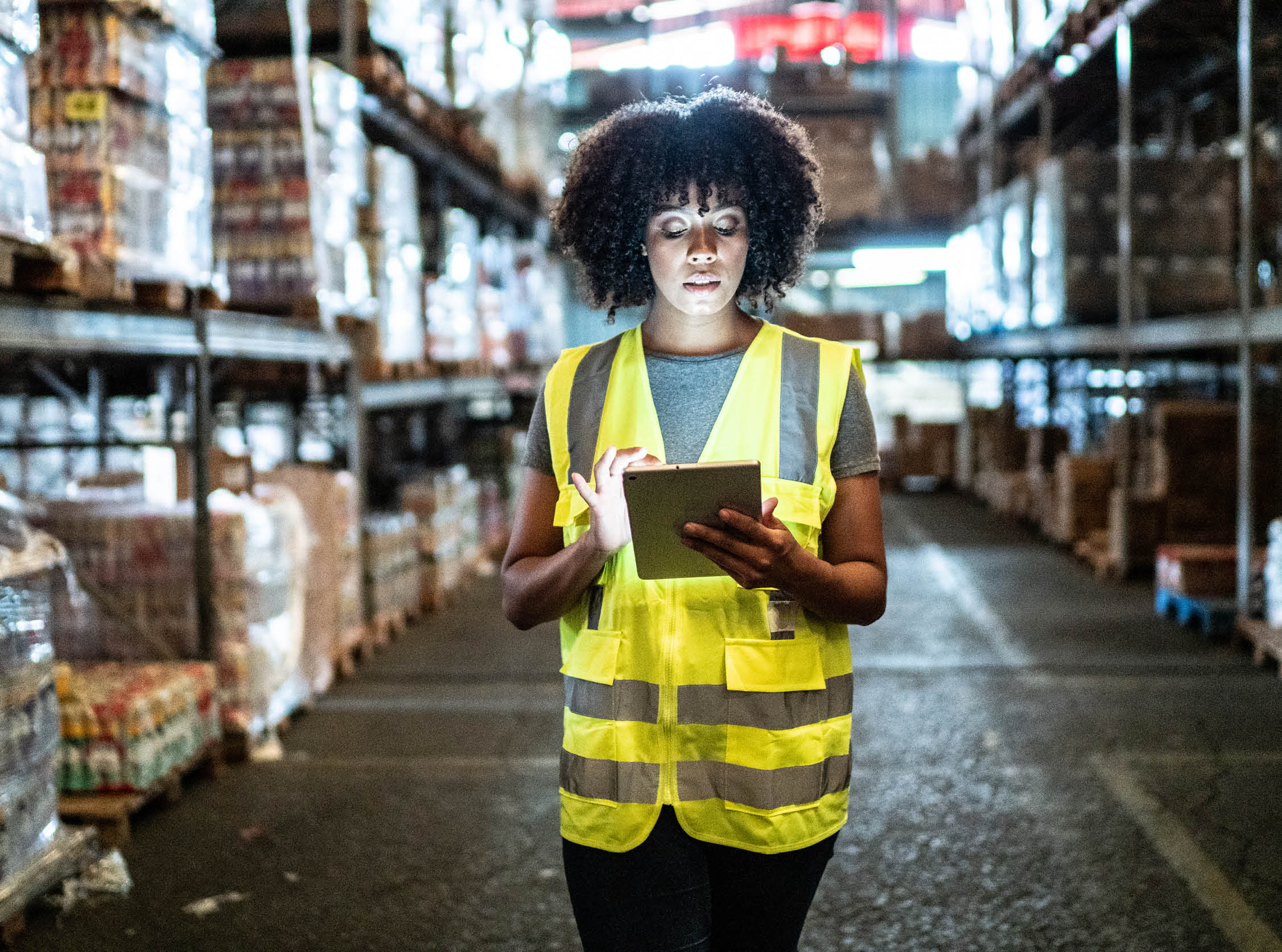 Young woman using the digital tablet in a warehouse