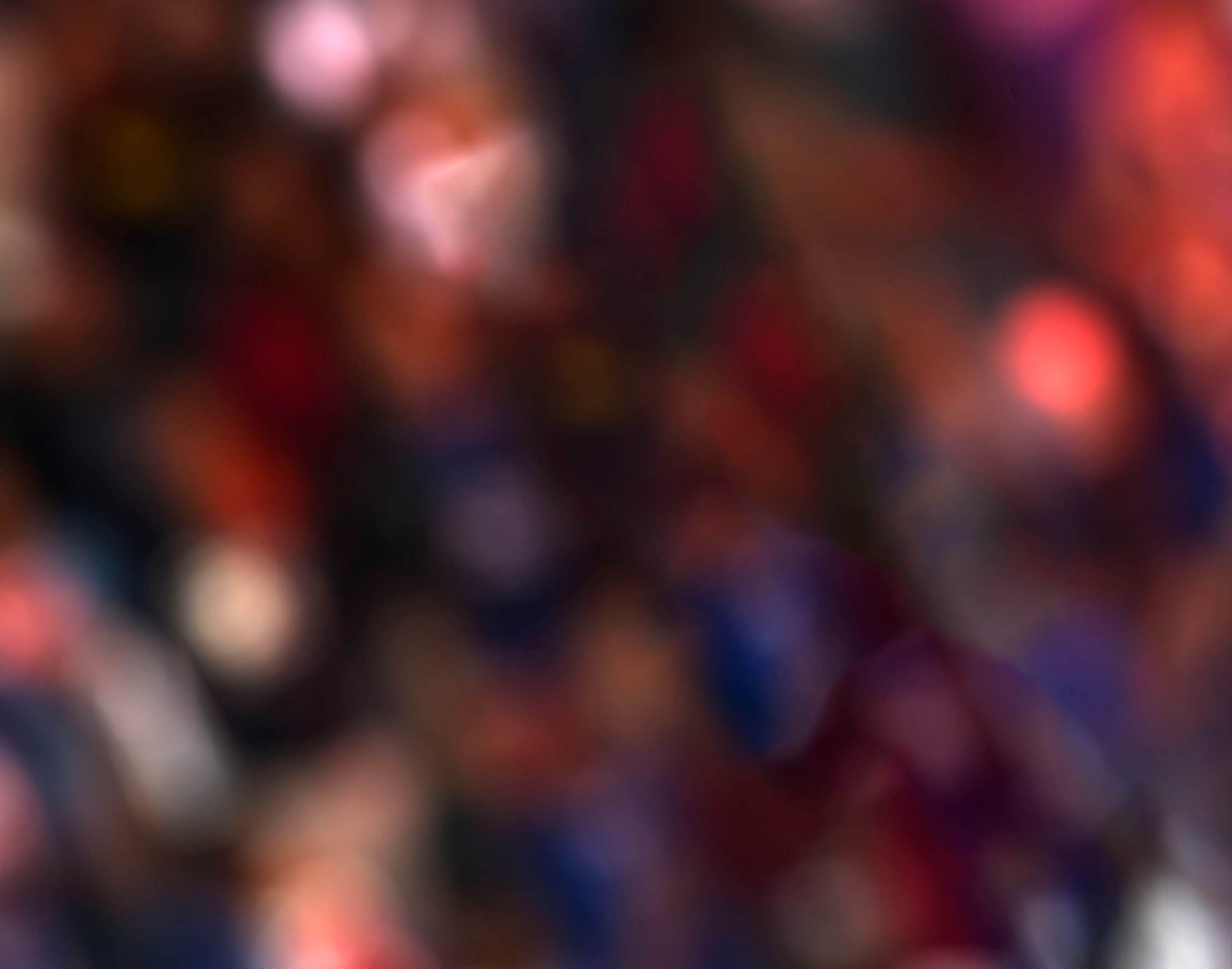 The referee raises his hand and shows a red card in a football match.