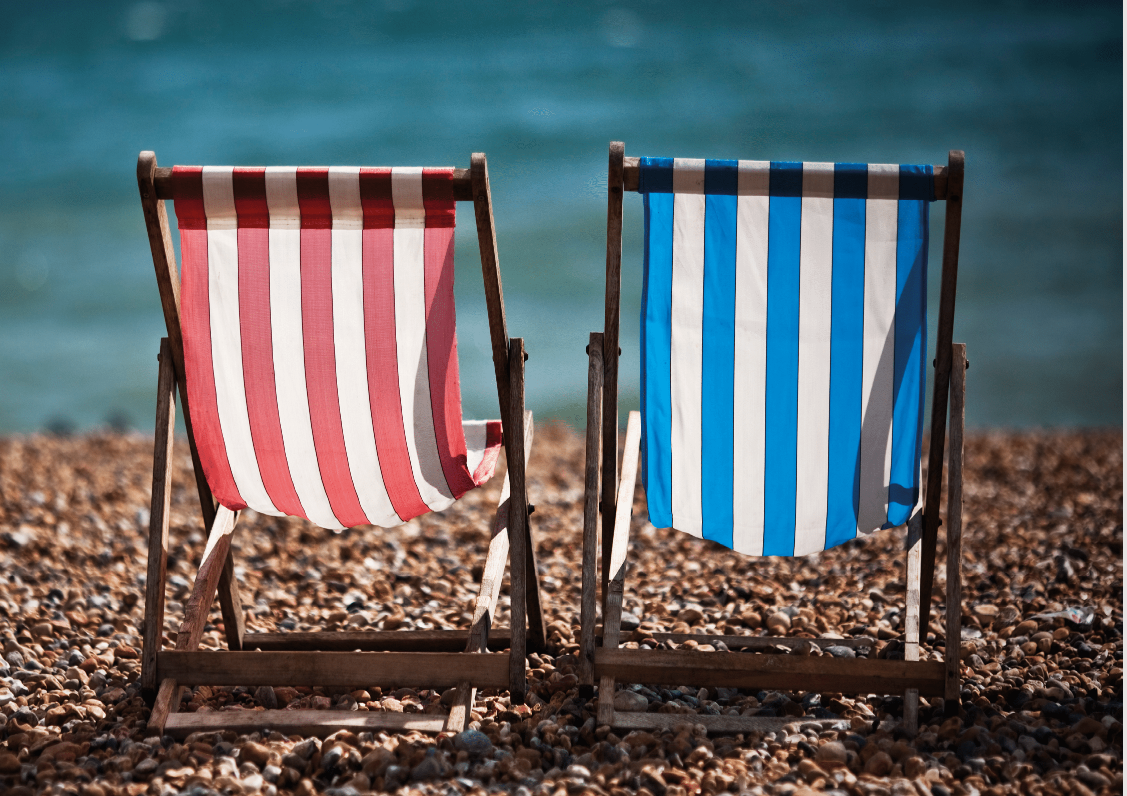 Deckchairs sit empty on Brighton beach.