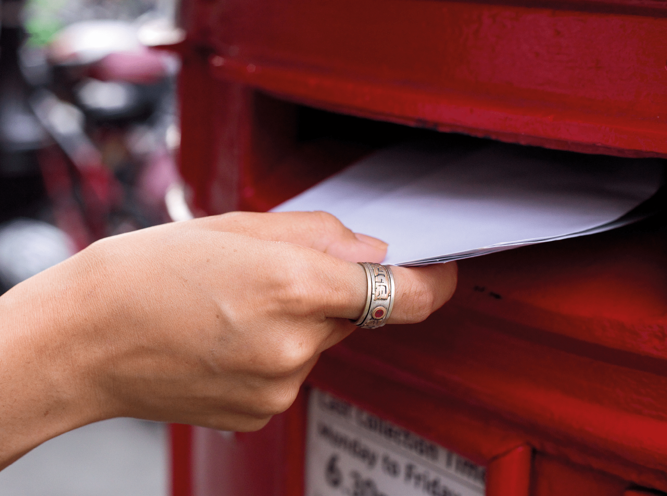 a hand posting letters
