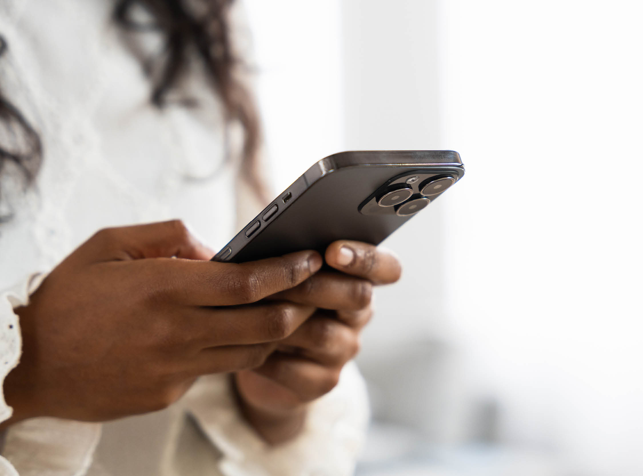Closeup of hands using phone. Unrecognisable black person using phone with copy space